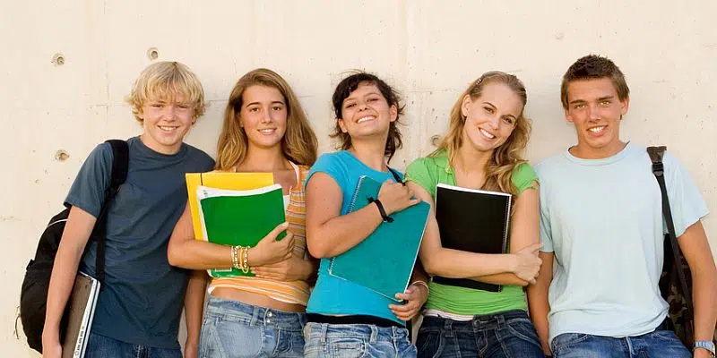 group of teens students hanging out at school